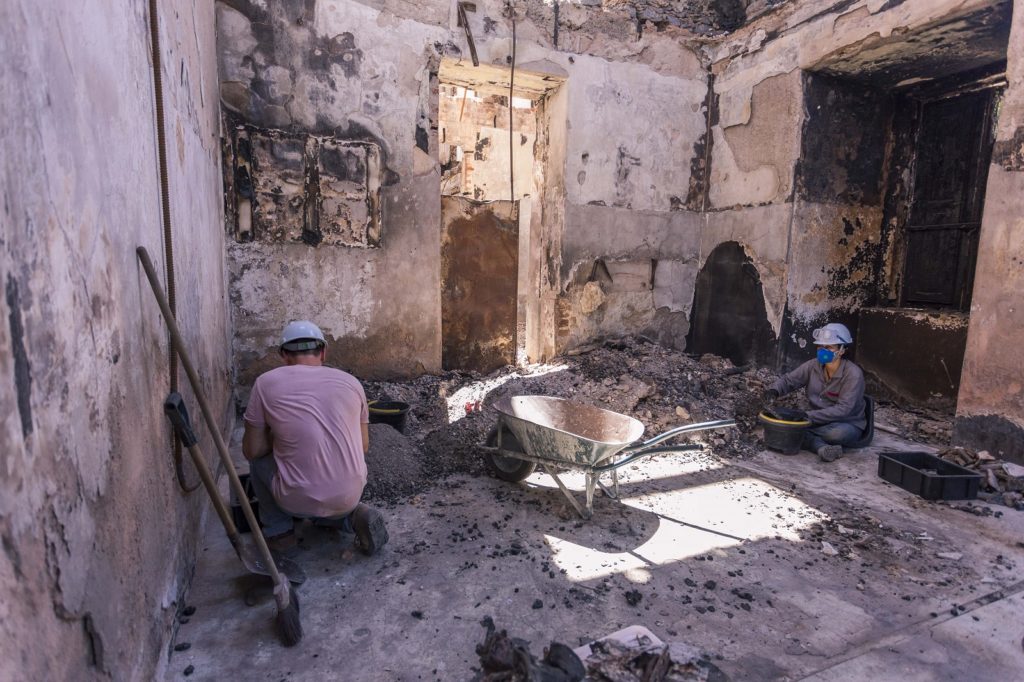 Workers cleaning after fire damage